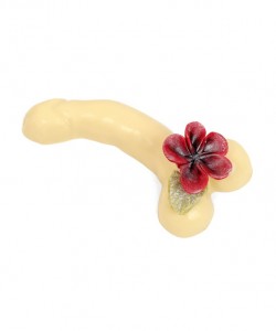 a white chocolate willy or penis or cock decorated with a flower on a white background